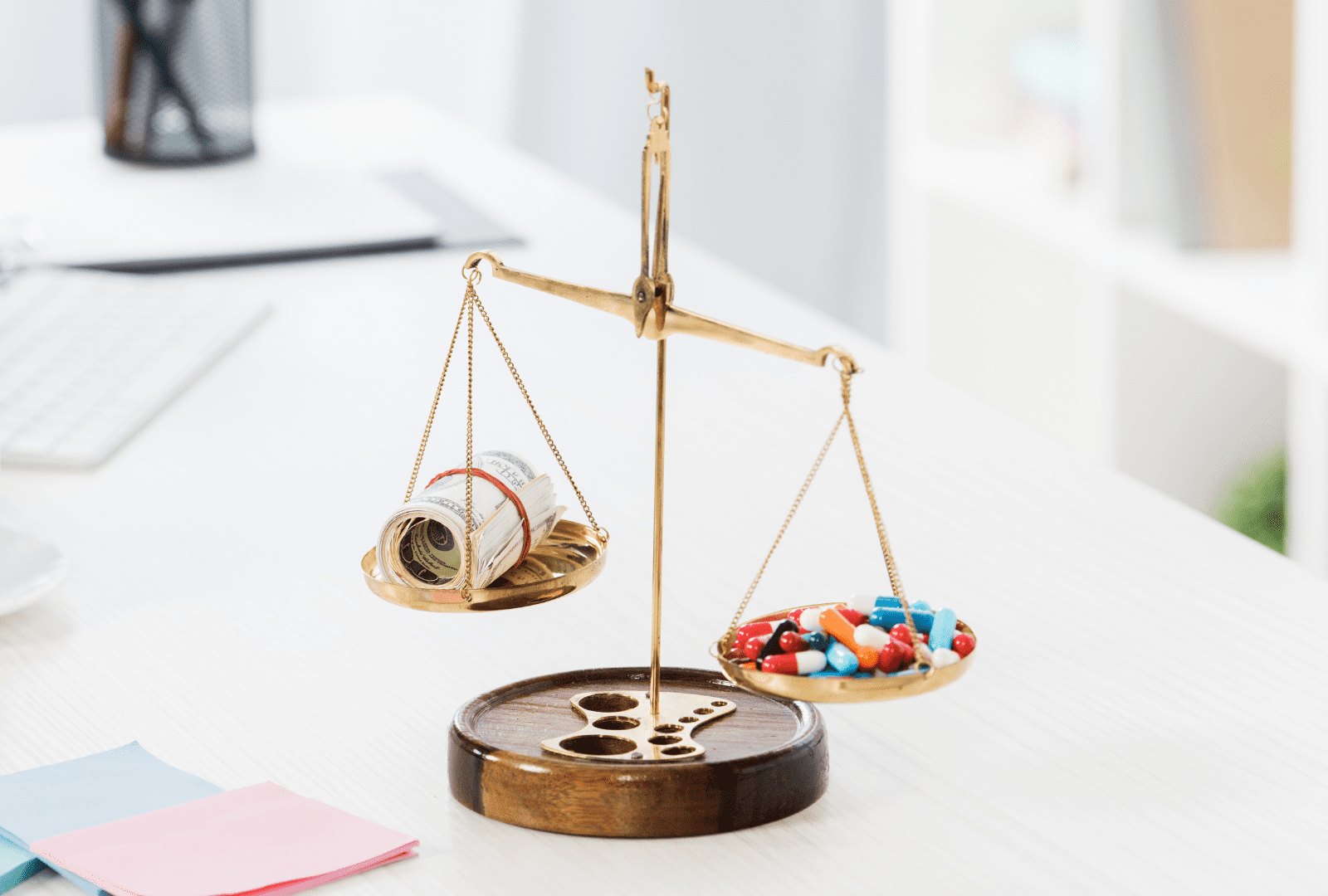 scale of justice with money and pill
